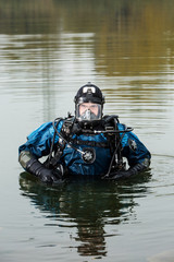 brave diver rescuer comes out of the water