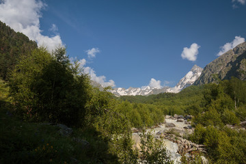 Obraz premium Movement of clouds and water flows in a stormy river in the Caucasus mountains in summer