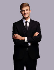 portrait in full growth. successful businessman with arms crossed in front of him.