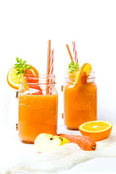 Carrot smoothie in a jar isolated