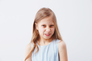 The dissatisfied girl frowns, has an ugly expression, expresses non-compliance, irritates someone,...