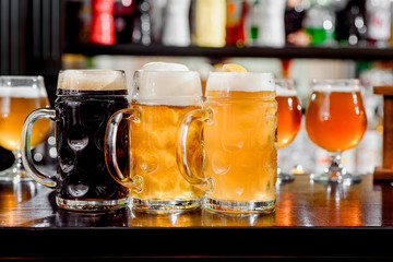 Glasses of light and dark beer on a bar counter. pub. liter glass