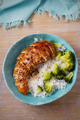 Glased chicken breast, rice and broccoli as garnish. Chicken in balsamic vinegar and brown sugar sauce