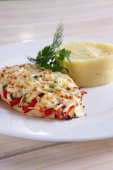 Fried chicken fillet with bell pepper, zucchini, melted cheese and mashed potato