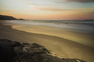 Long exposure of a Sunset at 'Praia Mole' beach. Colorful sky and reflexes in the water. Florianópolis, Santa Catarina / Brazil