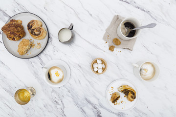 Overhead view of a breakfast spread with coffee and pastries