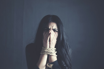 Young woman with tied up hands