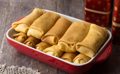 Pancakes stuffed with cottage cheese with sour cream and cup of tea. Breakfast. Sweet dessert of pancakes rolls.