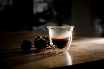 Transparent cup filled with hot and aromatic coffee drink