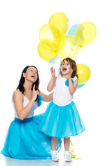 Mom and daughter with colorful balloons.