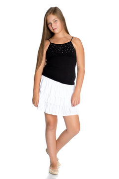 A teenage girl in a short white skirt and a black T-shirt.