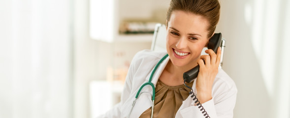 Happy doctor woman talking phone