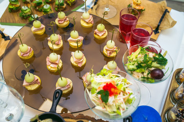 Beautifully decorated catering banquet table with different food snacks and appetizers.