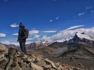 A young woman admires the mountain vista in the Mount Fitz Roy area near El Chalten Patagonia Argentina 