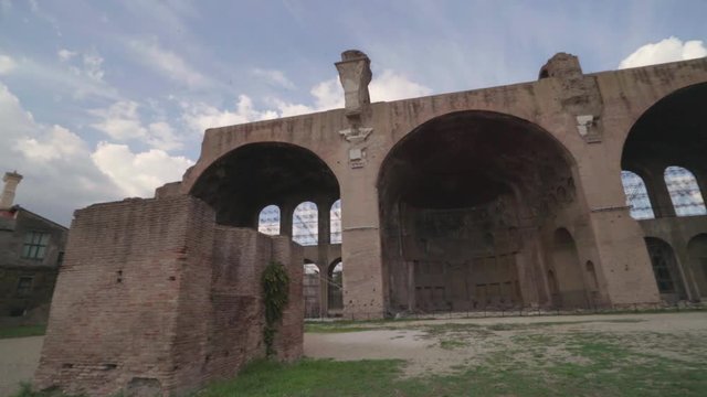 Wide angle shot panning across the Basilica of Maxentius in the Roman Forum
