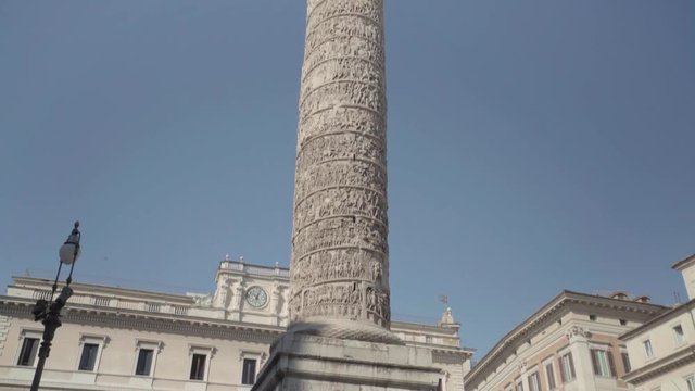 Camera tilting up across the entirety of the Column of Marcus Aurelius in Piazza Colonna in Rome