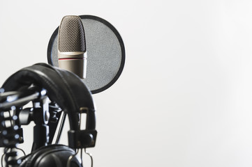 microphone and headphones in studio with white background