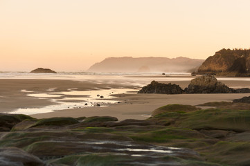Beautiful Sunset at Cannon Beach, Oregon. The popular resort areas of Cannon Beach and Arch Cape provide a scenic background for a stroll on soft white sand beach.