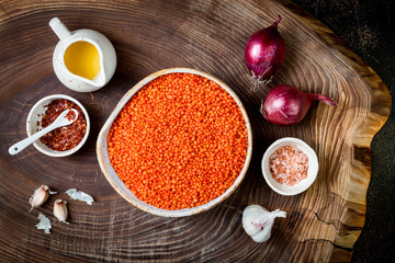 Cooking traditional red lentil Dal. Ingredients for Indian Dhal spicy curry. Top view, overhead - obrazy, fototapety, plakaty