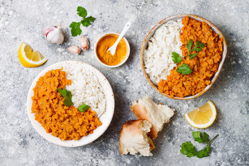 Traditional red lentil Dal. Indian Dhal spicy curry in bowl with flat bread and spices. Top view,...