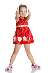 Little girl holding her thumb up