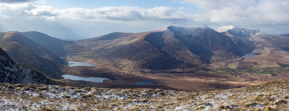 Panoramic view of mountain range on the Dingle Peninsula in County Kerry, Ireland showing Brandon Peak and Mount Brandon with snow