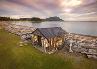 Classic Beach Cabin Covered in Crab Floats. Aerial view of an old fisherman's cabin on the shores of Lummi Island, Washington, USA.