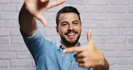 Facial Expressions Of Young Beard Man On Brick Wall