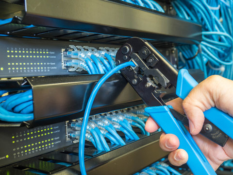 Repair Network Cable In Rack Cabinet And Hand To Crimping Pliers Tool