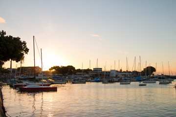 Fototapeta premium Sunset with Sailboats anchored in the pier