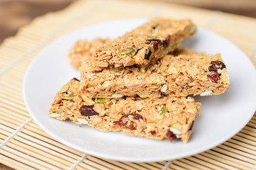 Snack bar or energy bar on white dish, healthy food