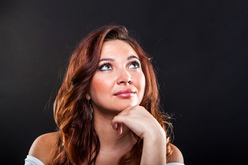 Pretty young girl on black background in studio