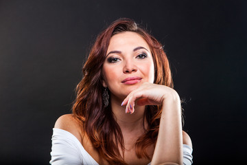 Fototapeta premium Pretty young girl on black background in studio