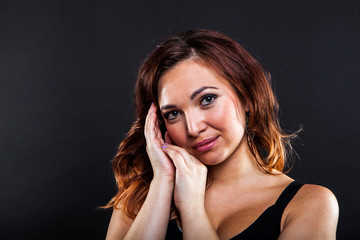 Obraz premium Pretty young girl on black background in studio