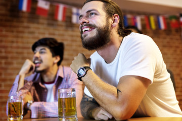 Friends cheering in a sports bar together