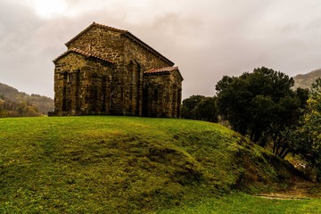 Fototapeta na wymiar St Christine of Lena is a pre romanesque church in the province of Asturias Spain with beautiful mountains and valleys all around.