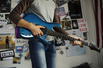 Teenage boy playing an electric guitar 