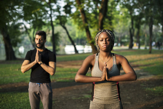 People doing yoga in a park