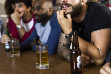 Frieds cheering sport at bar together