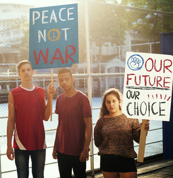 Group Of Teenagers Protesting Demonstration Holding Posters Antiwar Justice Peace Concept