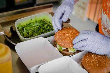 Fast food hamburgers take-away production cooking background