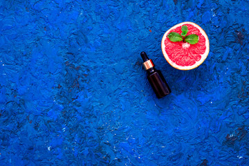 Natural citrus cosmetics. Spa salt near grapefruit on blue background top view mockup