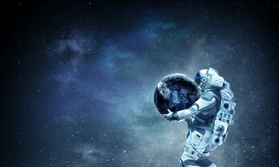 Obraz na płótnie Canvas Spaceman carry his mission. Mixed media