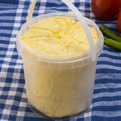 two fresh butter curls on white background