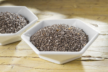 Chan beans in bowl on old wooden background (Salvia hispanica)