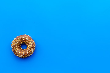 glazed donut for dessert on blue background flat lay mock up