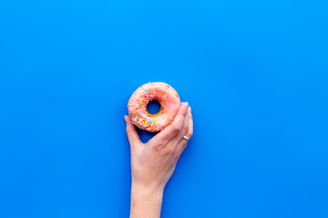 glazed donut for dessert on blue background flat lay mock up