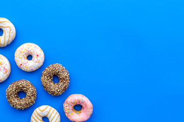 glazed donut for dessert on blue background flat lay mock up