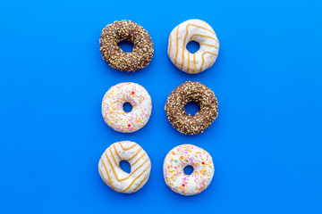 glazed donut for dessert on blue background flat lay mock up