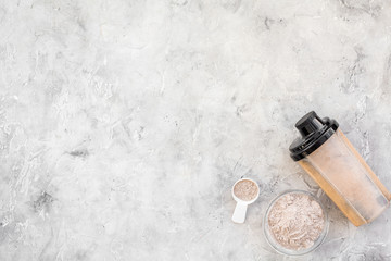 nutrition for workout with protein cocktail, powder on stone background top view mockup